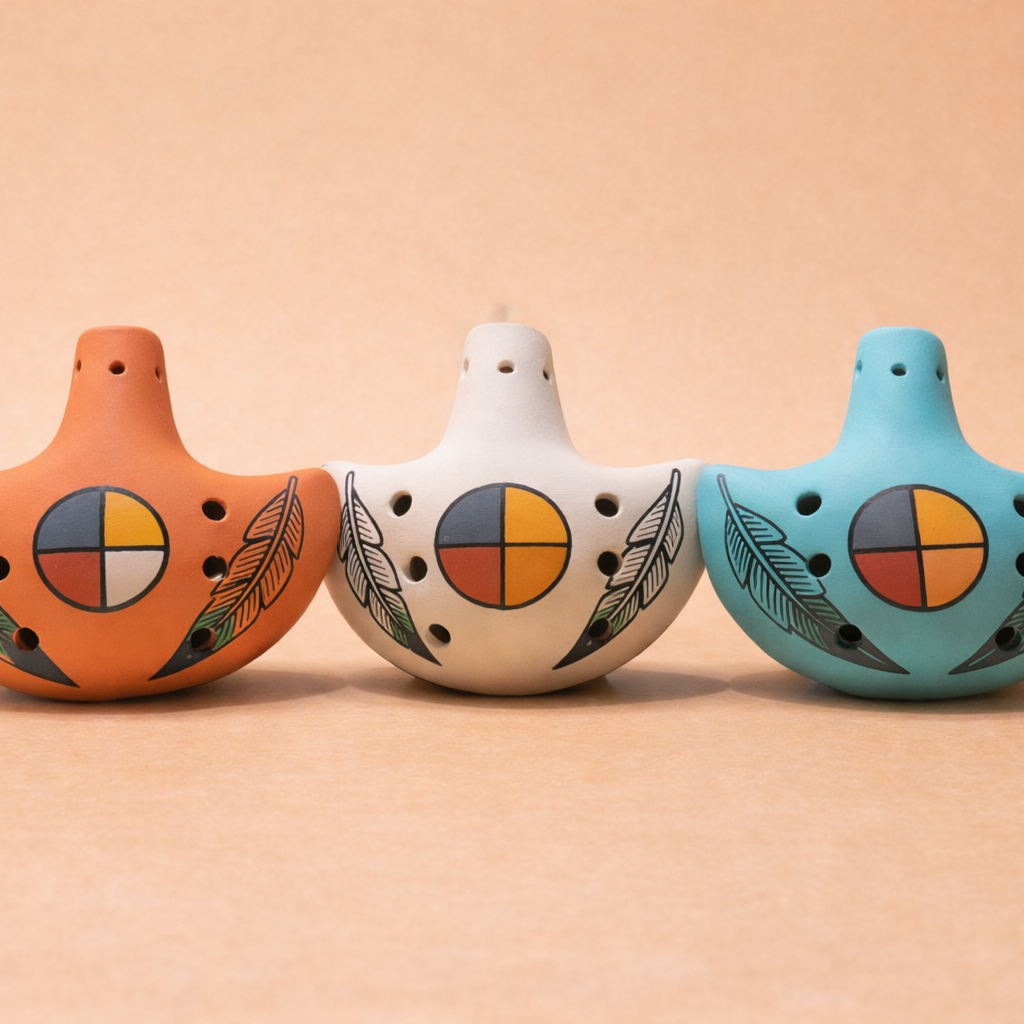 Handmade ceramic ocarina flutes in sandstone, turquoise, and terracotta with feather and medicine wheel design