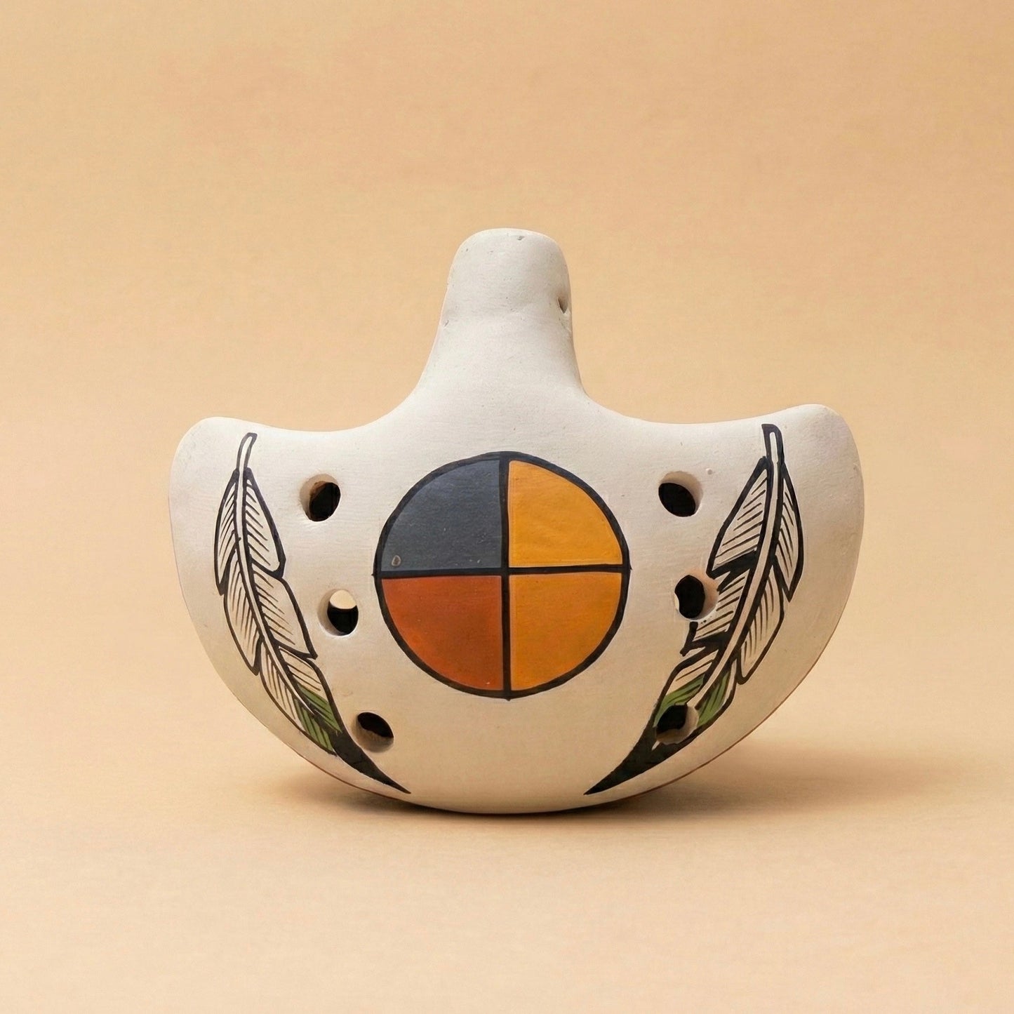 Handmade ceramic ocarina flute in sandstone with feather and medicine wheel design